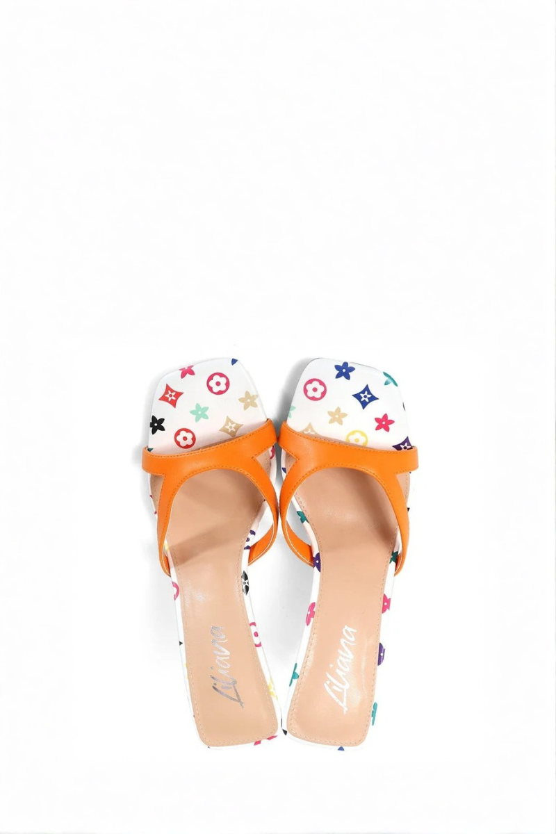 High-heeled shoe with orange strap and multicolored pattern on white background