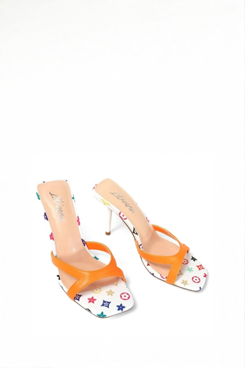 High-heeled shoe with orange strap and multicolored pattern on white background