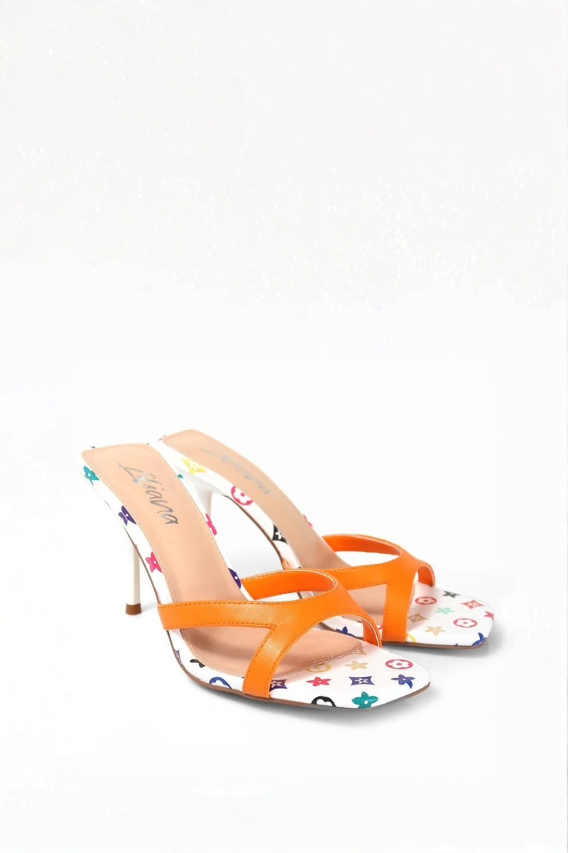 High-heeled shoe with orange strap and multicolored pattern on white background