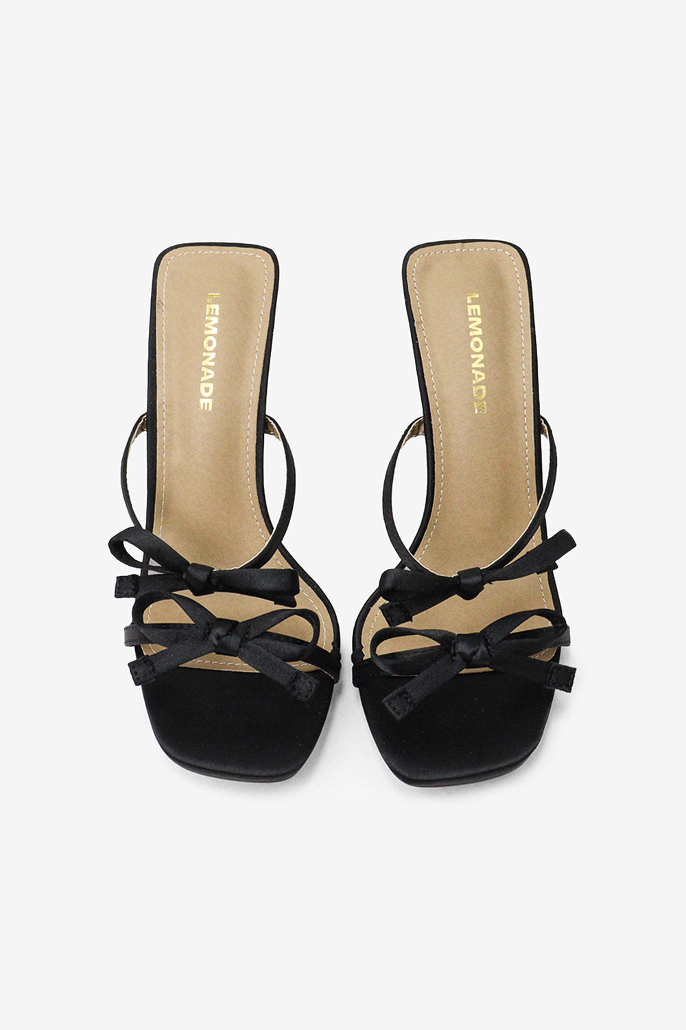 A pair of black high heel mules with square toes and multi-bow details on the straps.
