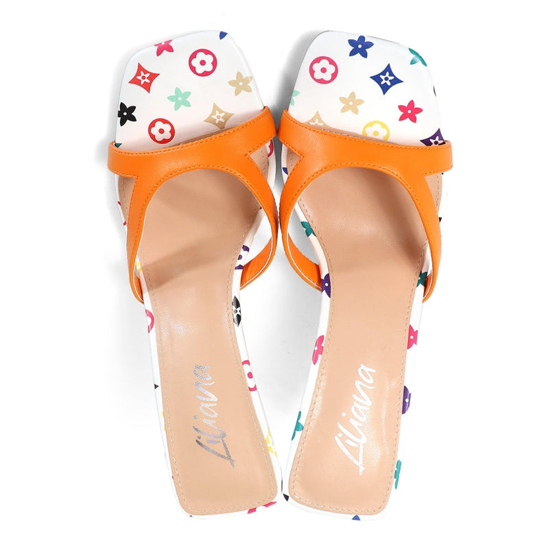 Pair of orange-heeled shoes with colorful pattern on a white background