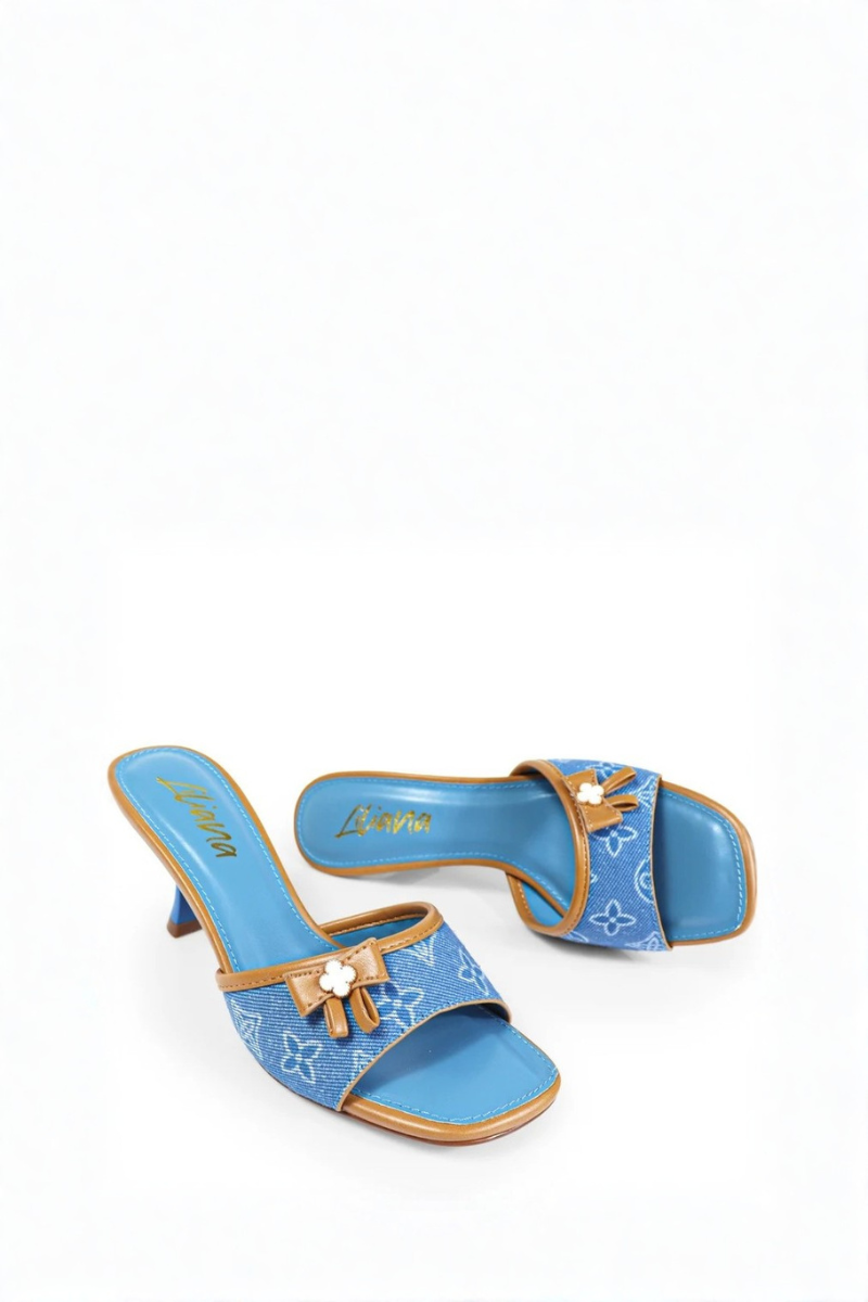 Blue high-heeled shoe with brown bow on a white background