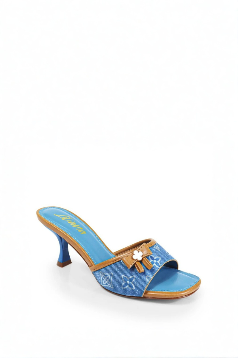 Blue high-heeled shoe with brown bow on a white background